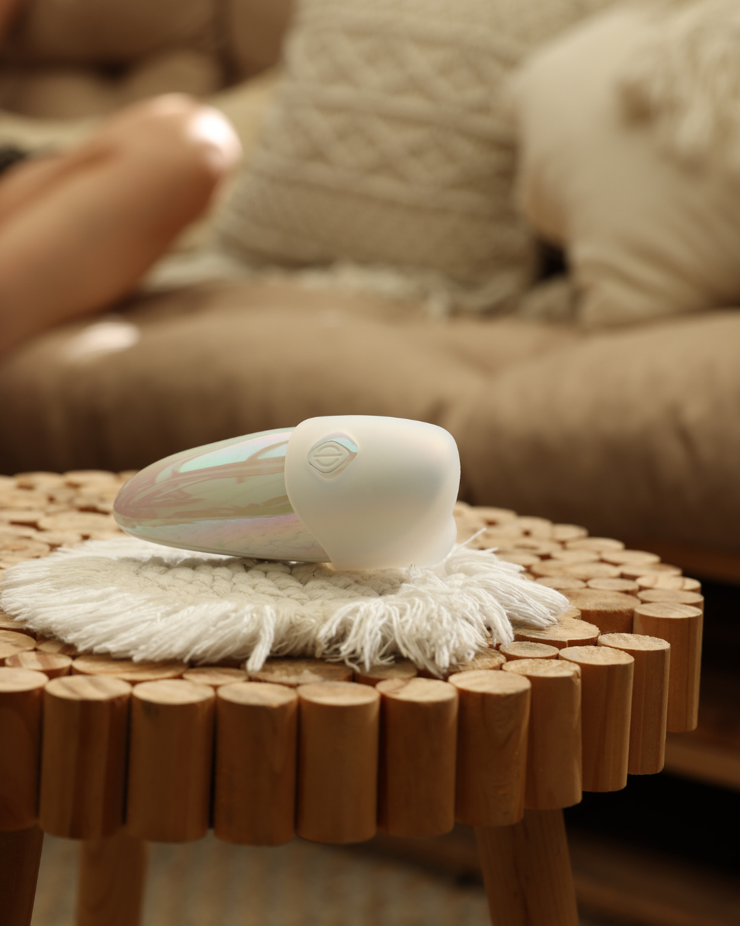 White hair dryer with colorful accents on a textured surface, blurred background